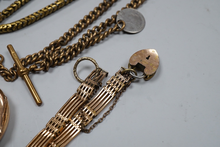 A group of gilt metal/pinchbeck jewels, 19th and early 20th century, comprising: a brooch of knotted design; two gate bracelets; a fancy link bracelet; an open-faced pocket watch; two oval panel brooches, and two watch c